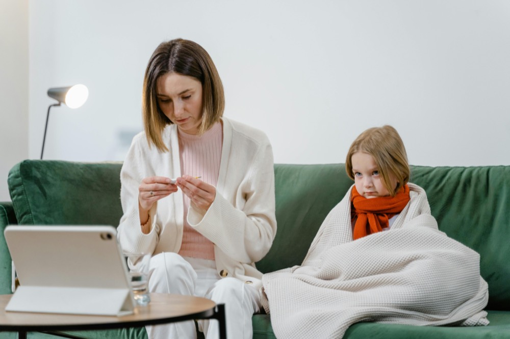A parent and child on a video visit at home